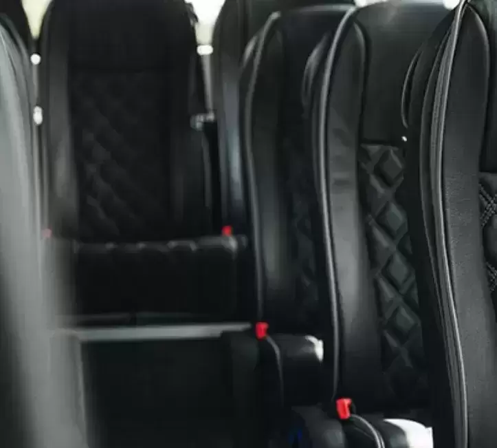 Luxury coach seats with black leather upholstery